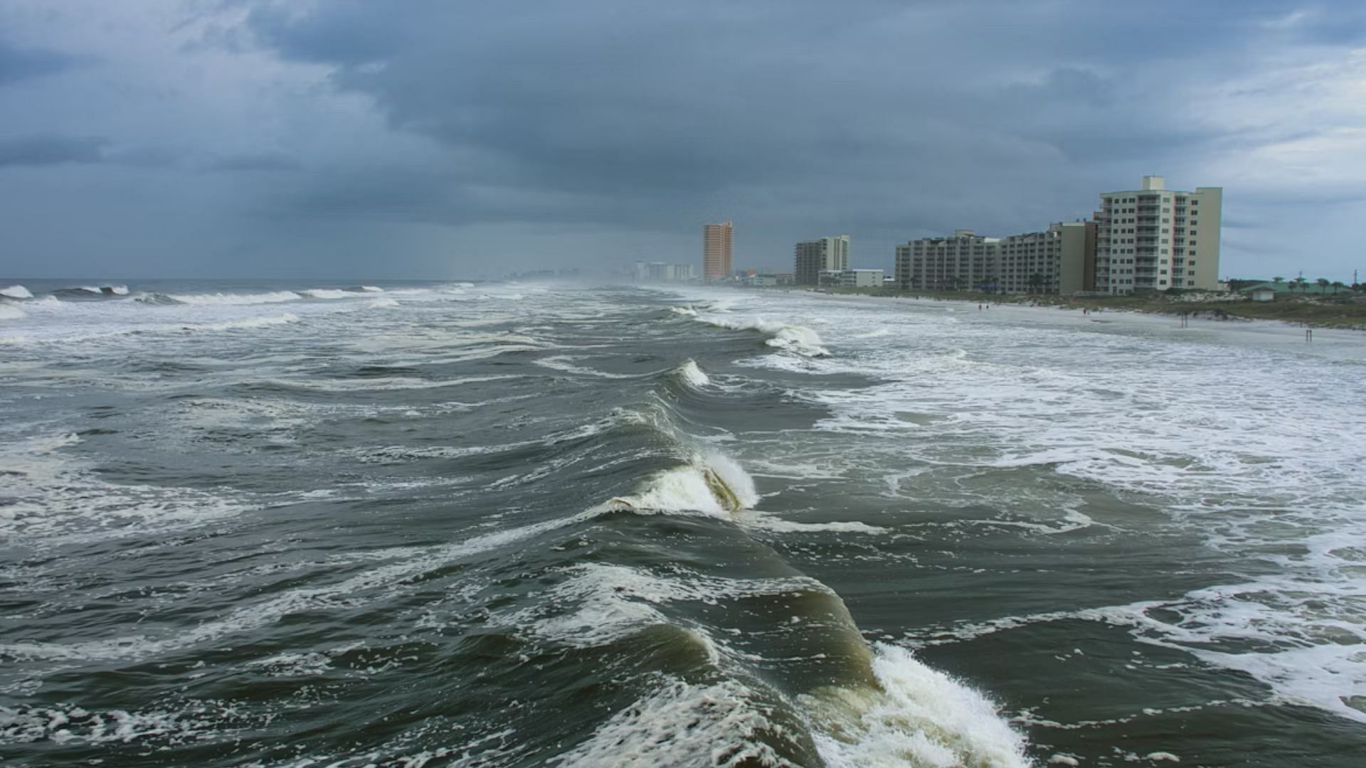 Tidal waves battering coastline (Image via Unsplash/ @ Craig Cameron)